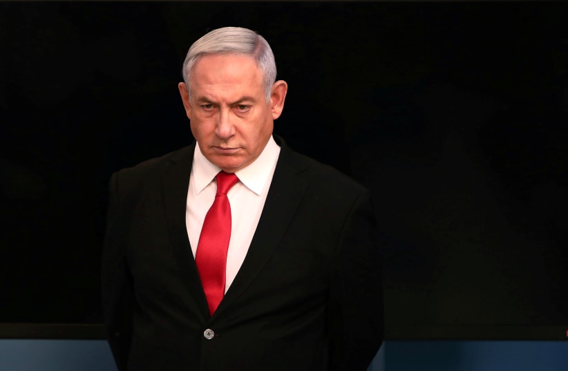 Israeli Prime Minister Benjamin Netanyahu arrives for a speech at his Jerusalem office, regarding the new measures that will be taken to fight the coronavirus, March 14, 2020 (photo credit: REUTERS/GALI TIBBON/POOL)