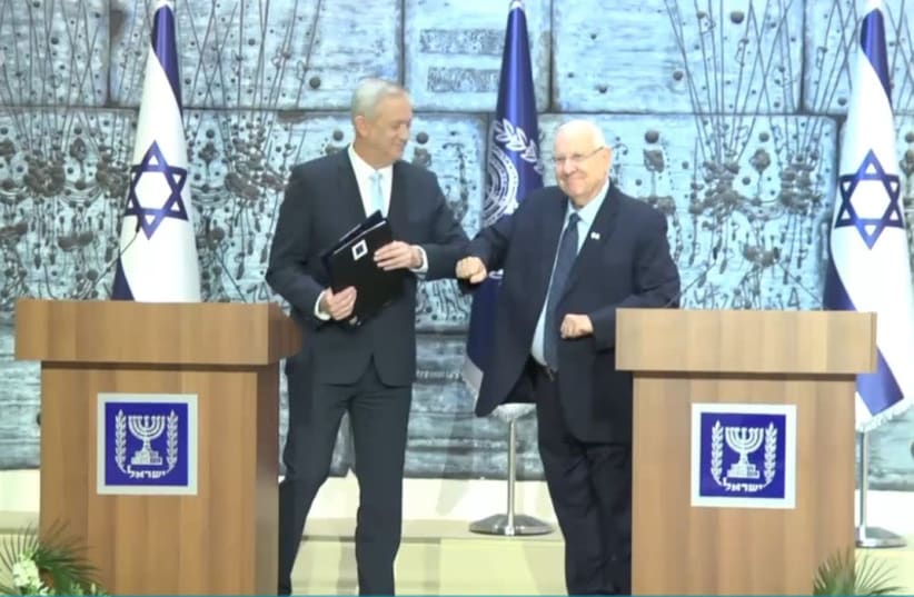 Blue and White leader Benny Gantz receives mandate to form a government from President Reuven Rivlin as they avoid shaking hands due to the coronavirus outbreak (photo credit: GOVERNMENT PRESS OFFICE)