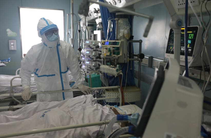 Medical worker is seen at the intensive care unit (ICU) of Jinyintan hospital in Wuhan, the epicentre of the novel coronavirus outbreak (photo credit: REUTERS)