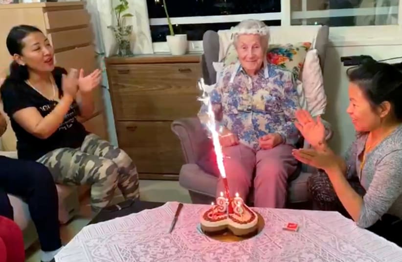 Ester Wienrib, an Israeli Holocaust survivor celebrates her 97th birthday with her caretaker and friends at her assisted living facility in Tel Aviv (photo credit: REUTERS TV)