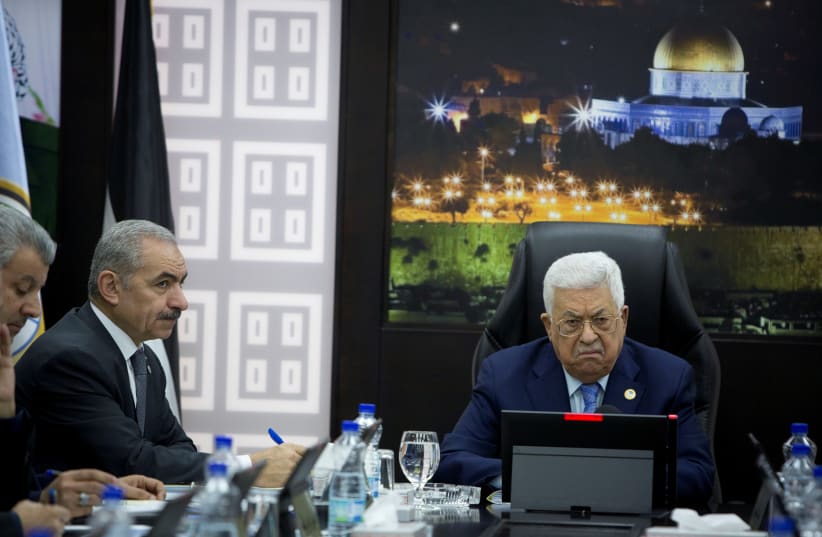Palestinian President Mahmoud Abbas chairs a session of the weekly cabinet meeting with Palestinian Prime Minister Mohammad Shtayyeh, in Ramallah  (photo credit: REUTERS)