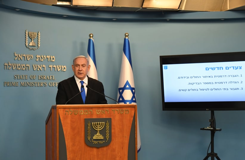 Prime Minister Benjamin Netanyahu is seen addressing the State of Israel with updates to the ongoing coronavirus outbreak. (photo credit: KOBI GIDEON/GPO)