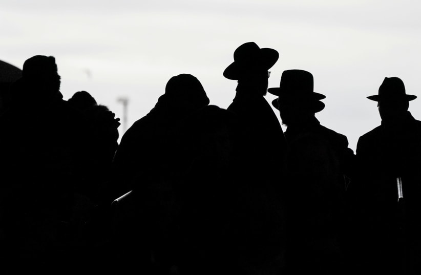 Orthodox Jews arrive during the 13th Siyum HaShas, a celebration marking the completion of the Daf Yomi, a seven-and-a-half-year cycle of studying texts from the Talmud, the canon of Jewish religious law, at the MetLife Stadium in East Rutherford, New Jersey, U.S. (photo credit: REUTERS/JEENAH MOON)