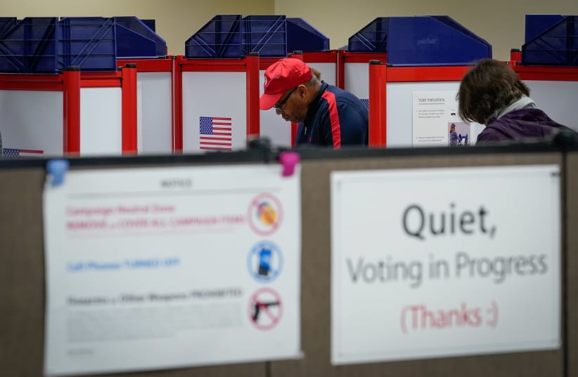 Voters fill in their ballot during a period of early voting at the Board of Elections office in Cincinnati, Ohio, U.S. March 14, 2020 (photo credit: BRYAN WOOLSTON/REUTERS)