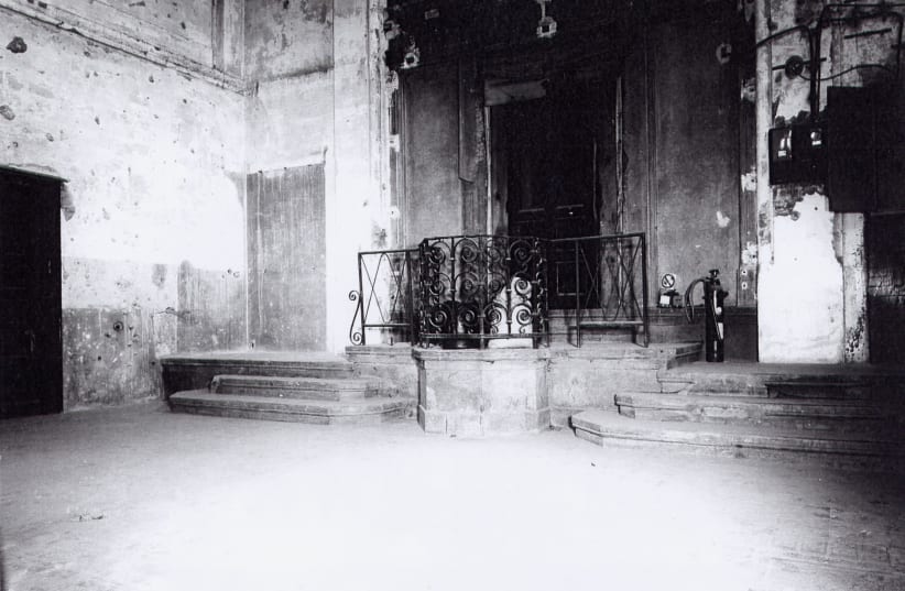 THE BIMAH in the ‘small temple’ after the war, when it became a furniture warehouse (photo credit: Courtesy)