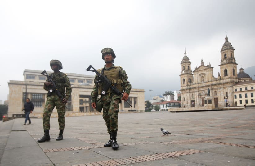 Members of the military walk in Bolivar Square during the four-day mandatory isolation decreed by the mayor of Bogota, as a preventive measure against the spread of the coronavirus disease (COVID-19), in Bogota, Colombia March 20, 2020. (photo credit: REUTERS)