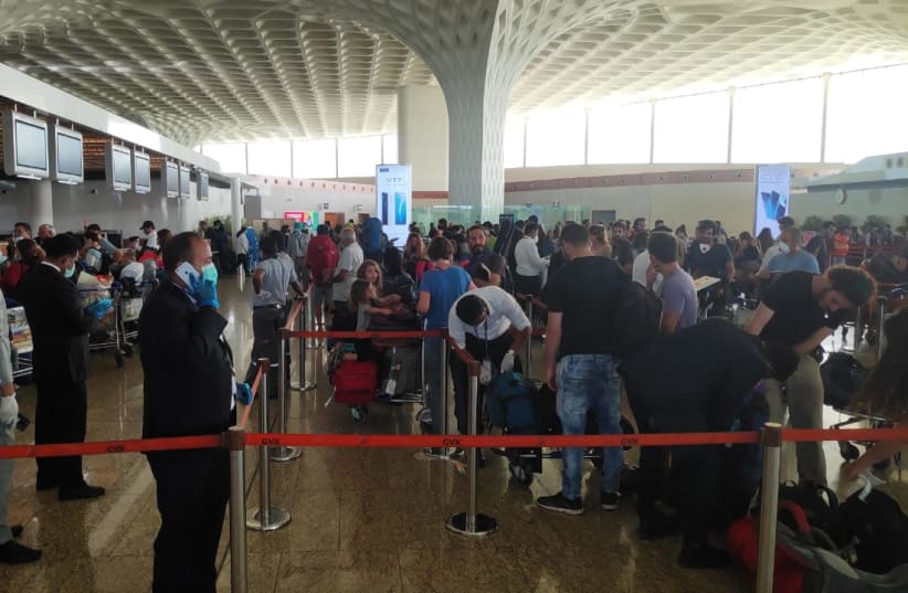 Israelis stranded in India board a special El Al flight to return them to Israel amid the coronavirus outbreak. (photo credit: EL AL)