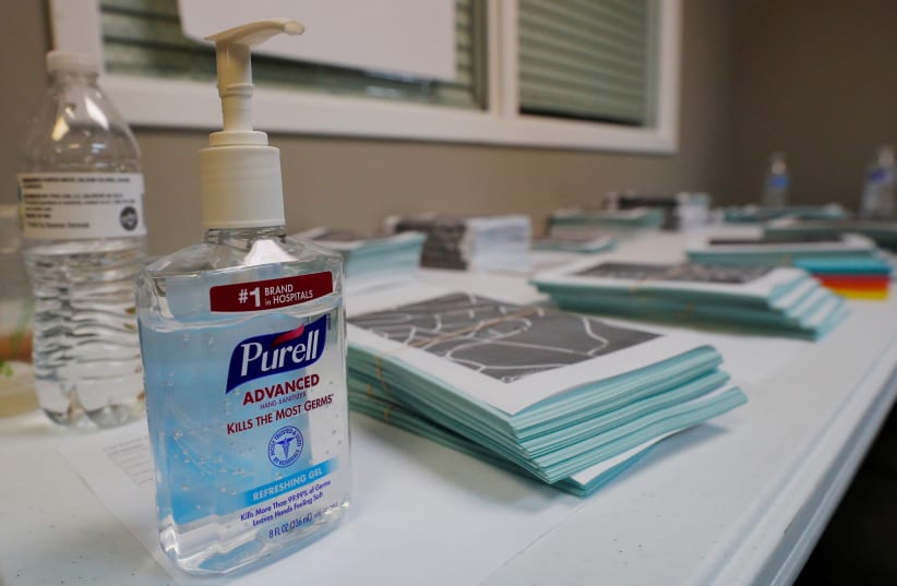 A bottle of Purell hand sanitizer sits next to campaign canvass packets at a field office for Democratic 2020 U.S. presidential candidate and U.S. Senator Elizabeth Warren (D-MA) in Graniteville, South Carolina, U.S., February 28, 2020 (photo credit: REUTERS)