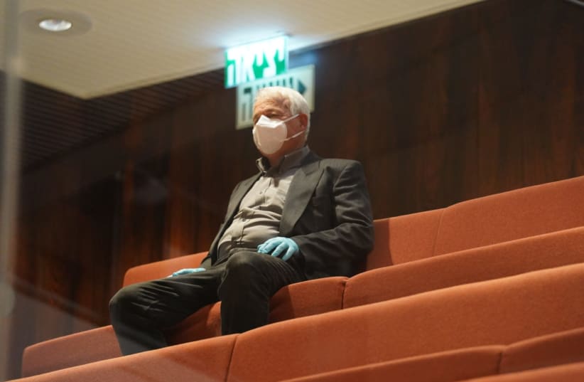 Blue and White MK Alon Schuster getssworn into the Knesset from the press gallery wearing masks and gloves, March 23, 2020 (photo credit: KNESSET SPOKESPERSON'S OFFICE)