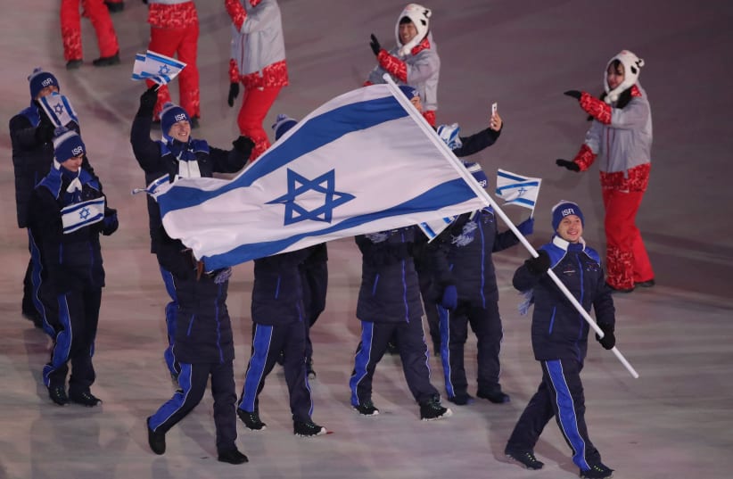 Pyeongchang 2018 Winter Olympics – Opening ceremony – Pyeongchang Olympic Stadium - Pyeongchang, South Korea – February 9, 2018 - Alexei Bychenko of Israel carries the national flag.  (photo credit: CARLOS BARRIA / REUTERS)