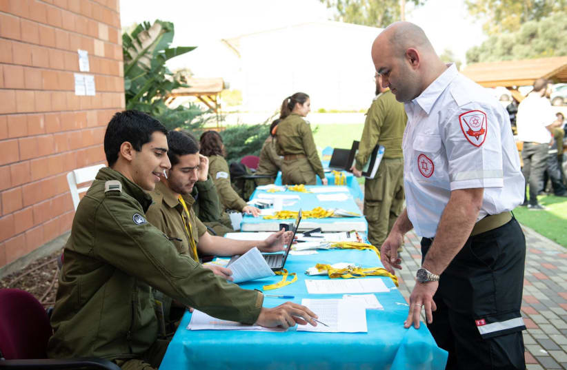An IDF officer and Magen David Adom official speak (photo credit: IDF SPOKESPERSON'S UNIT)