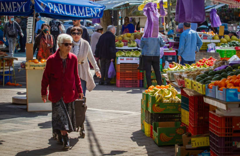 OLDER PEOPLE shop at the market in Netanya on Wednesday. The government ordered all bars, restaurants, malls and markets to close, in an effort to contain the spread of the coronavirus.  (photo credit: FLASH90)