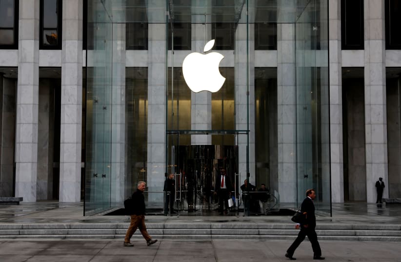 FILE PHOTO: The Apple Inc. logo is seen hanging at the entrance to the Apple store on 5th Avenue in Manhattan, New York, U.S., October 16, 2019 (photo credit: REUTERS/MIKE SEGAR/FILE PHOTO)