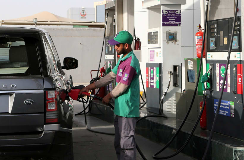 A worker fills a vehicle with petrol at a gas station in Riyadh, Saudi Arabia, February 16, 2020. (photo credit: AHMED YOSRI/ REUTERS)