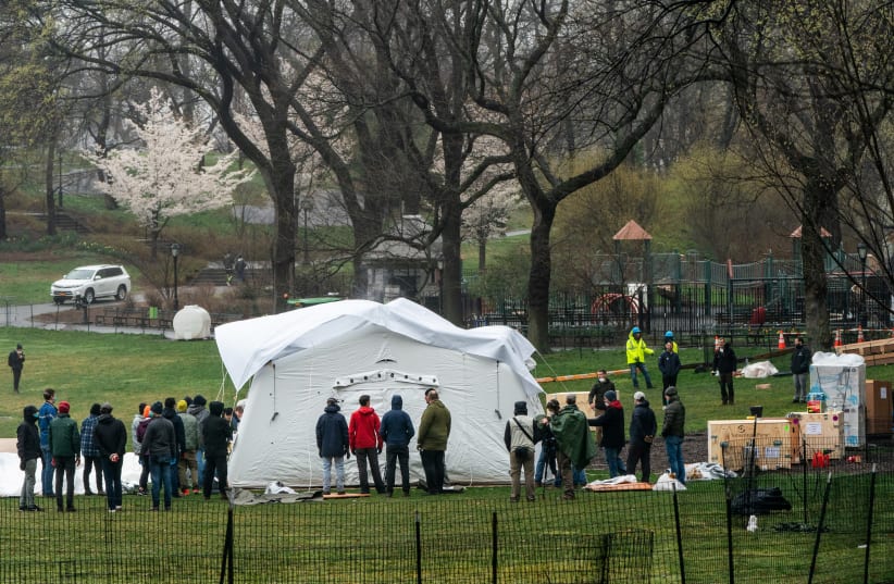 Samaritan’s Purse staffs set up an emergency field hospital in East Meadow in Central park during the outbreak of the coronavirus disease (COVID-19) in New York City, U.S., March 29, 2020 (photo credit: REUTERS)