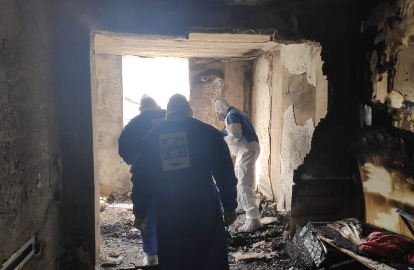 Firefighters inspect the aftermath of a fire, Petah Tikva, March 30, 2020 (photo credit: ZAKA)