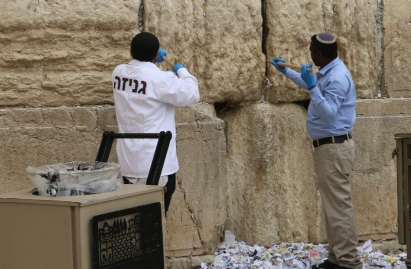 A special team collects notes placed at the Western Wall for the annual Passover removal. (photo credit: THE WESTERN WALL HERITAGE FOUNDATION)