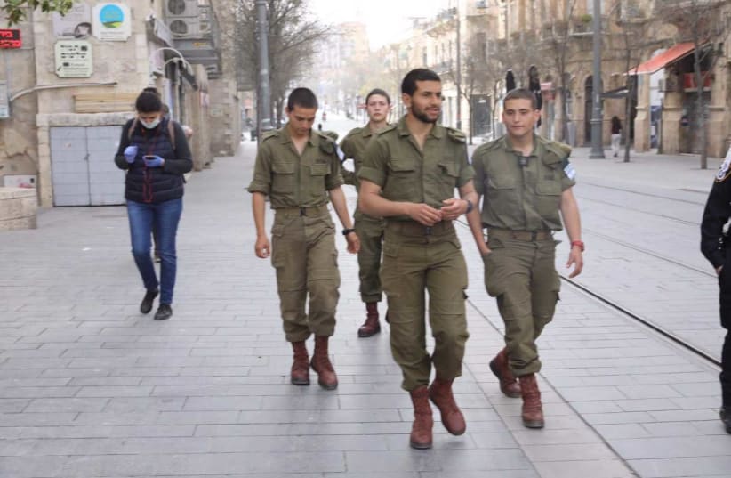 IDF soldiers walk on Jaffa Street, Jerusalem, March 31, 2020 (photo credit: MARC ISRAEL SELLEM/THE JERUSALEM POST)