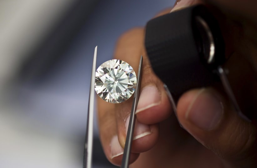 A trader inspects a diamond during a show at Israel's Diamond Exchange near Tel Aviv, Israel (photo credit: REUTERS)