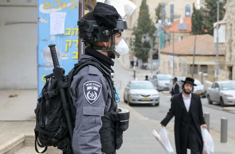 Border Police go about coronavirus inspections in Mea Shearim, a haredi neighborhood in Jerusalem. (photo credit: MARC ISRAEL SELLEM)