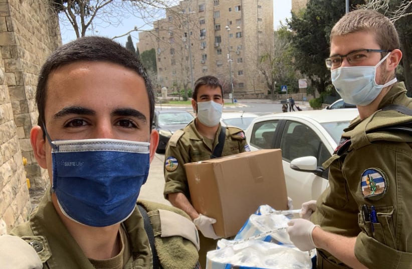 In the wake of the coronavirus, COGAT officers and soldiers deliver essentials to the needy and disabled in Jerusalem for Passover (photo credit: COGAT SPOKESPERSON'S OFFICE)