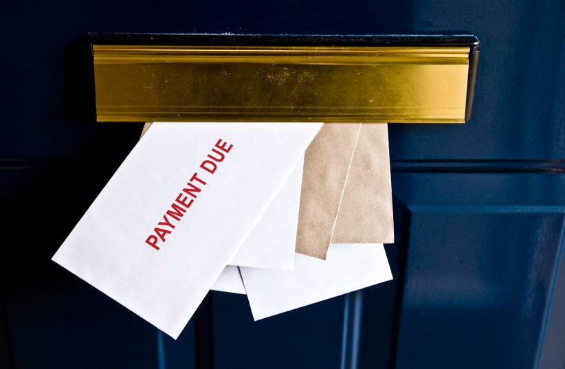 Letters in a letterbox saying "payment due" [Illustrative] (photo credit: GETTY IMAGES)