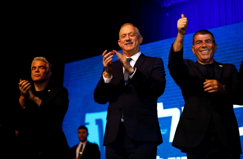 Former prime minister Ehud Olmert [C] with Yair Lapid [L] and Gabi Ashkenazi [R]   (photo credit: REUTERS)