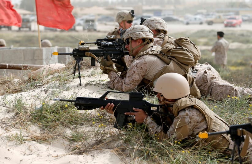 U.S. Navy Marines and Saudi Navy Special Force personnel take their positions during mixed maritime exercise with U.S. Navy and Saudi Royal Navy, at Saudi Military Port, Ras Al Ghar, Eastern Province, in Jubail, Saudi Arabia February 26, 2020. (photo credit: HAMAD I MOHAMMED / REUTERS)