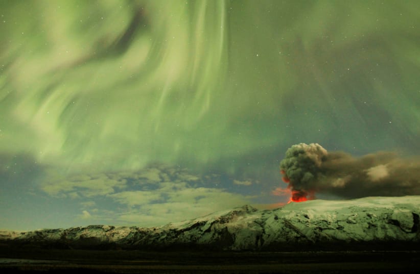 The Northern Lights are seen above the ash plume of a volcano in Eyjafjallajokull, Iceland, April 22, 2010 (photo credit: REUTERS)