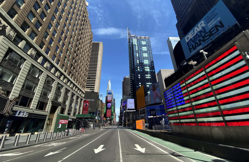 A nearly deserted 7th Avenue in Times Square is seen near midday in Manhattan during the outbreak of the coronavirus disease (COVID-19) in New York City, New York, U.S., April 7, 2020 (photo credit: REUTERS/MIKE SEGAR)