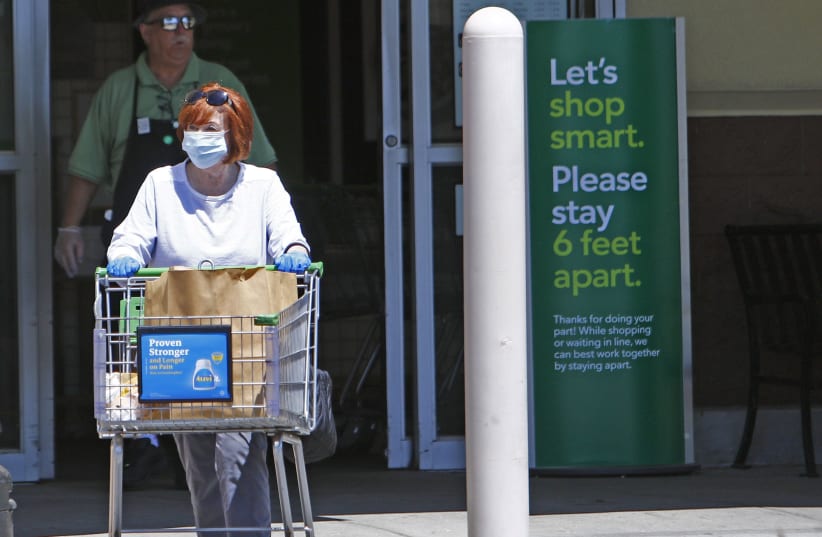 A PATRON exits a supermarket during the coronavirus pandemic.  (photo credit: TNS)