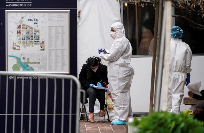 People arrive for testing during the outbreak of coronavirus disease (COVID-19) at George Washington University Hospital in Washington, U.S. April 10, 2020 (photo credit: REUTERS/JOSHUA ROBERTS)