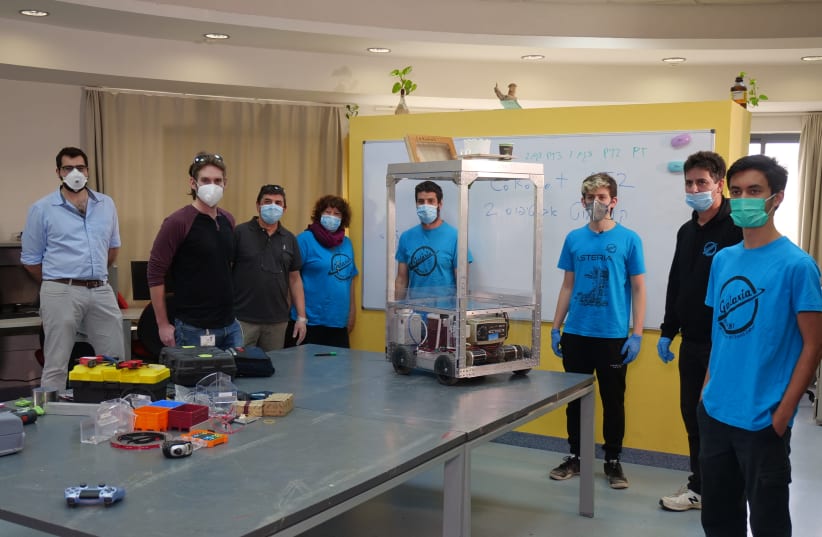 Experts from Technion and Rambam Medical Center posing with the COROBOT (photo credit: TECHNION SPOKESPERSON'S OFFICE AND RAMBAM SPOKESPERSON'S OFFICE)