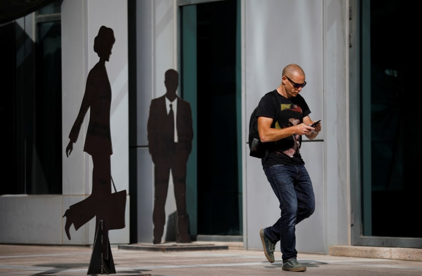 A man walks past sculptures in the high-tech business area of Tel Aviv (photo credit: REUTERS)