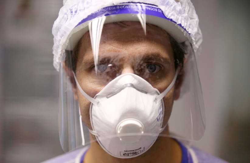 Doctor chief of the intensive care unit (ICU), Luiz Gustavo Marin poses for pictures at the Nossa Senhora da Conceicao hospital, where patients suffering from the coronavirus disease (COVID-19) are treated, in Porto Alegre, Brazil (photo credit: REUTERS)