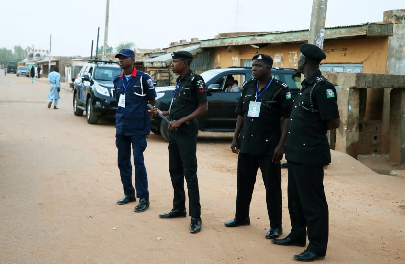 Police officers stand guard on a street before the start of Nigeria's presidential election in Daura, Katsina State, Nigeria, February 23, 2019 (photo credit: REUTERS/AFOLABI SOTUNDE)