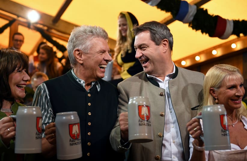 Munich mayor Dieter Reiter with his wife Petra and Bavarian State Prime Minister Markus Soeder with his wife Karin Baumueller hold beer at the opening day of the 186th Oktoberfest in Munich, Germany September 21, 2019. (photo credit: ANDREAS GEBERT/REUTERS)