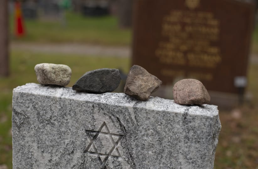 Placing stones on a headstone at a Jewish cemetery marks the memory of and honors the deceased. (photo credit: GETTY IMAGES)