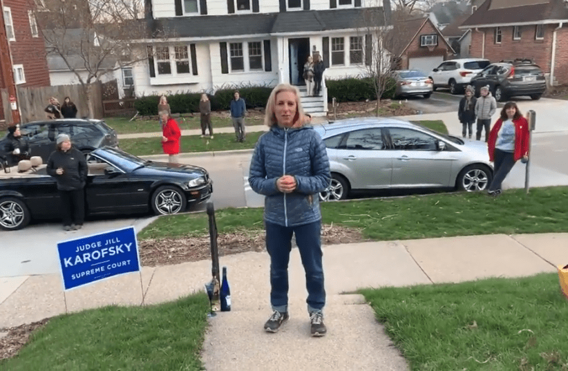 Jill Karofsky celebrates her election to Wisconsin's Supreme Court at a social distance outside her Madison home, April 13, 2020 (photo credit: SCREENSHOT/JTA)