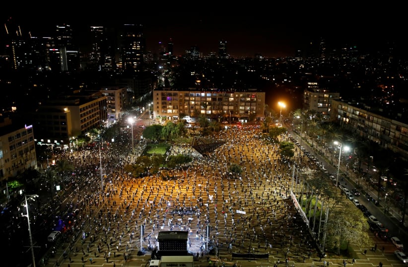 PEOPLE PROTEST against Prime Minister Benjamin Netanyahu in Tel Aviv.  (photo credit: REUTERS)
