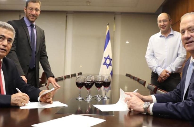 Labor Party leader Amir Peretz and Blue and White leader Benny Gantz sign coalition agreement, April 24, 2020 (photo credit: COURTESY LABOR PARTY SPOKESPERSON)