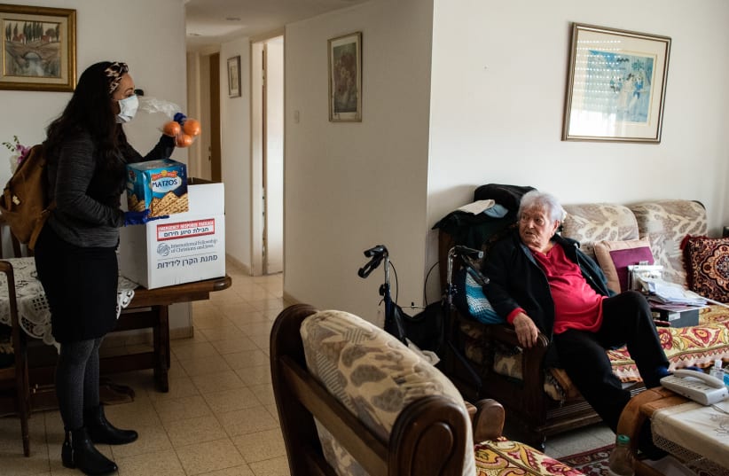 Yael Eckstein delivers food and sanitary products to Yelena Meirovitz in Hadera, Israel, one of 30,000 elderly The Fellowship is serving during the coronavirus pandemic (photo credit: IFCJ)