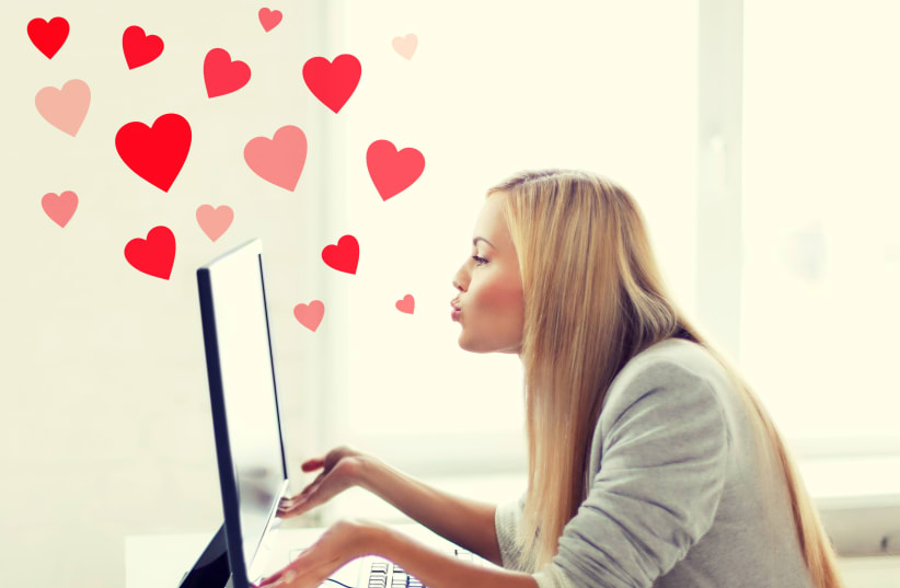 Virtual relationships, online dating and social networking concept - woman sending kisses with computer monitor (photo credit: INGIMAGE)