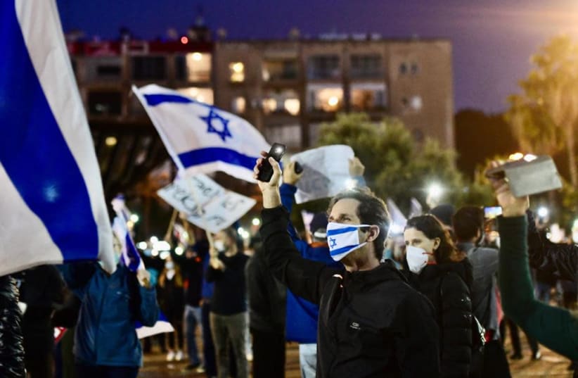 Thousands of protestors are seen at Tel Aviv's Rabin Square Saturday participating in a Black Flag demonstration against the new coalition agreement. (photo credit: AVSHALOM SASSONI/ MAARIV)