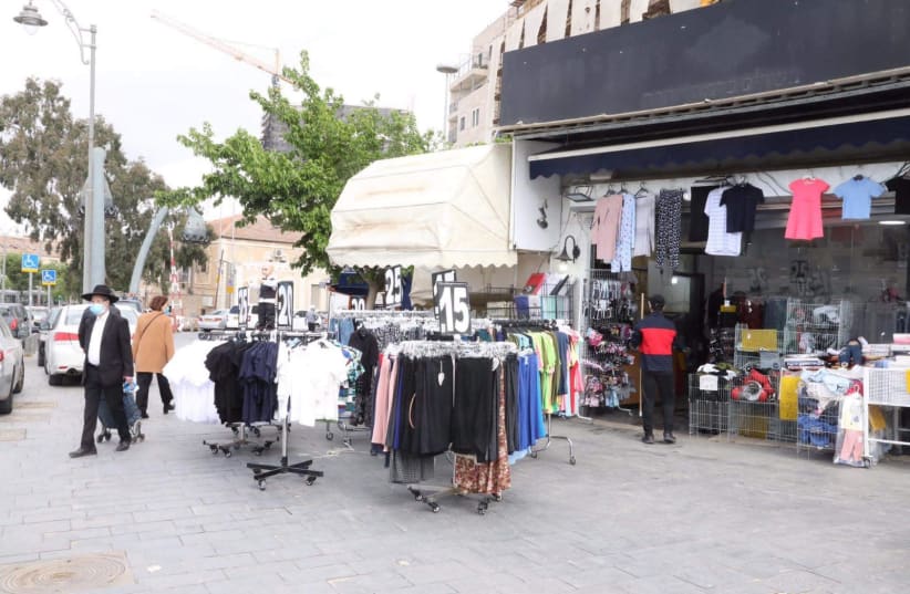 Shops begin to open in Jerusalem's Mahane Yehuda Market as the coronavirus restrictions on business are eased, April 26, 2020 (photo credit: MARC ISRAEL SELLEM/THE JERUSALEM POST)
