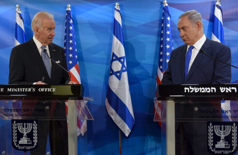 Then-US Vice President Joe Biden (L) and Israeli Prime Minister Benjamin Netanyahu look at each other as they deliver joint statements during their meeting in Jerusalem March 9, 2016 (photo credit: DEBBIE HILL/REUTERS)