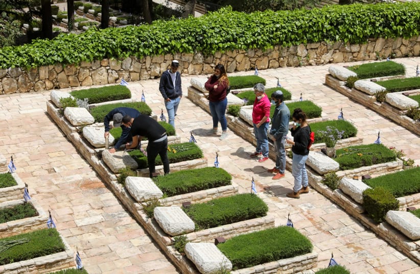 bereaved families visit the graves of their fallen loved ones ahead of Israel's Memorial Day (photo credit: MARC ISRAEL SELLEM/THE JERUSALEM POST)