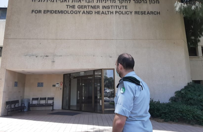 Maj. A, who usually researches Iran’s nuclear project, stands outside the National Coronavirus Information Center. (photo credit: IDF)