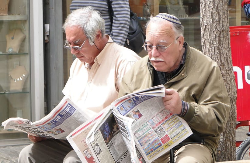 Reading morning paper in Jerusalem (photo credit: WIKIMEDIA)
