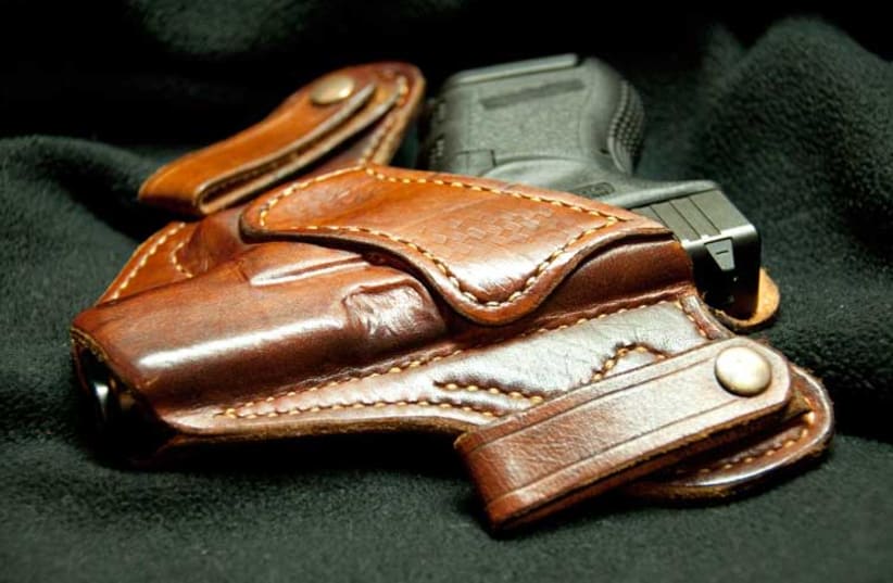 Gun in a holster (Illustrative) (photo credit: Wikimedia Commons)
